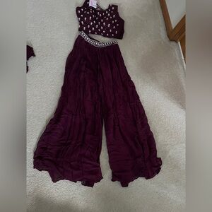 It is brand new indian dress with crop top with plazo bottoms with open kurta.